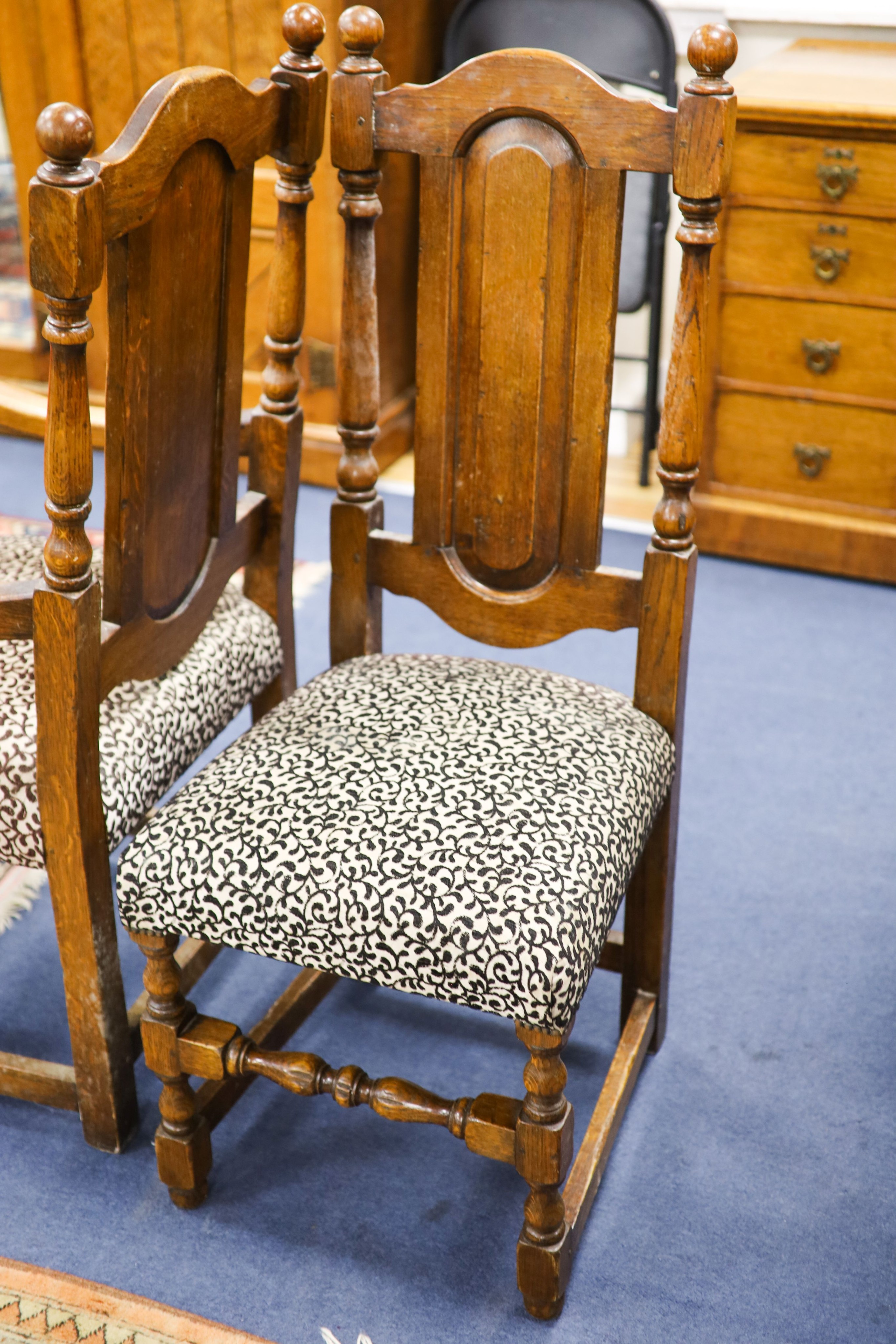 A set of ten 18th century style panelled oak dining chairs, two with arms